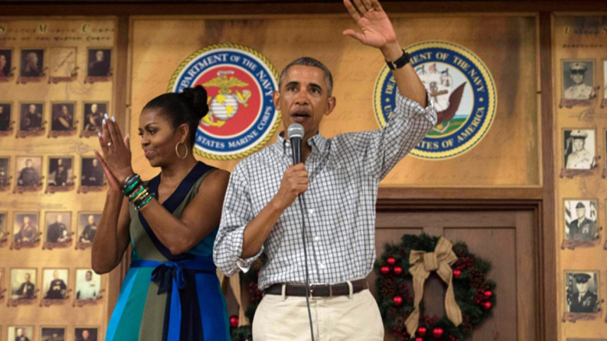 US President Barack Obama addresses troops with First Lady Michelle Obama
