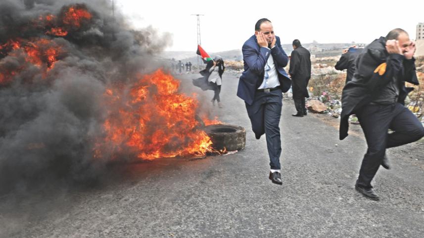 Palestinian lawyers run during clashes