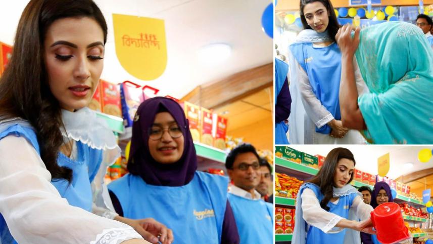 Bidya Sinha Mim serves customers at Bidyanondo’s store