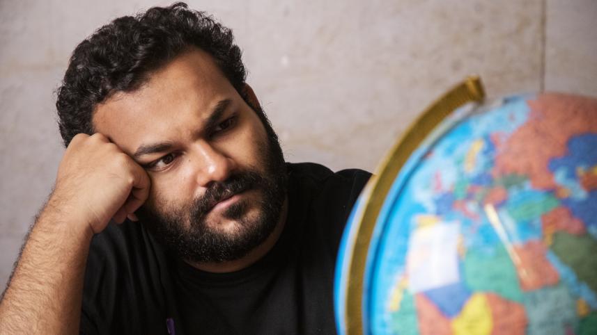 A person looking at a globe with concern.