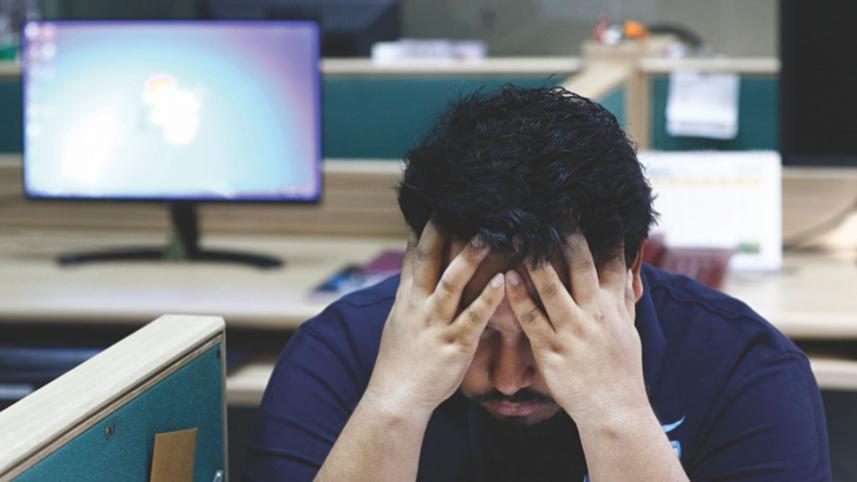 Person with their hands on their head, visibly stressed. 