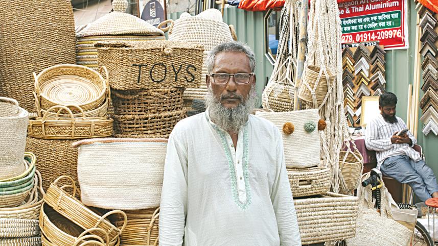 Elderly vendor selling beautifully stitched jute bags and mats