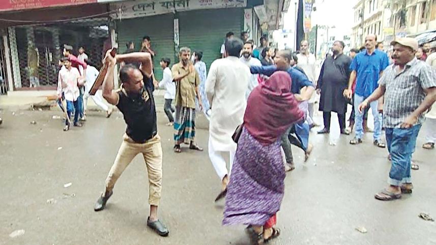 A protester being beaten up allegedly by an Awami League activist near upazila intersection in Narsingdi