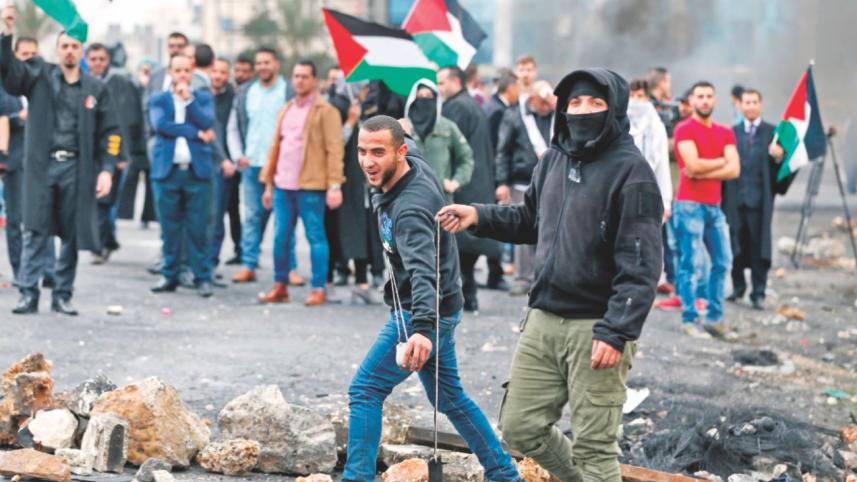 Palestinian protestors throw stones