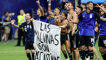 Argentina players hold Falklands banner after semifinal