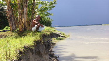 Jatramohan Barman sits beside the Dharla River, watching the land he once farmed disappear to erosion in Lalmonirhat's Moghalhat Union. Photo: Star