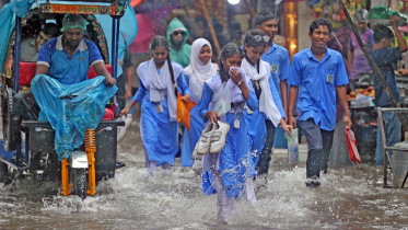 Students wade through submerged streets of the capital. 