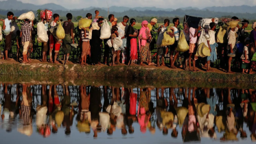 1. Rohingya refugees carry their belongings as they flee Myanmar for Bangladesh.png