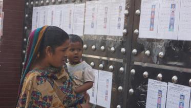 An apparel worker is gazing at the list of sacked labourers