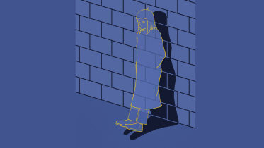 Girl standing against a brick wall, all in blue