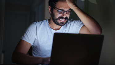 Frustrated man using computer