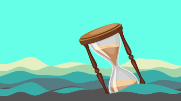 A sand clock resting amidst the mountains. 