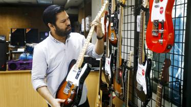 A man holding a guitar.