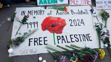 People leave notes and flowers during a vigil for US Air Force active-duty airman Aaron Bushnell outside the Israeli Embassy on February 26, 2024 in Washington, DC.
