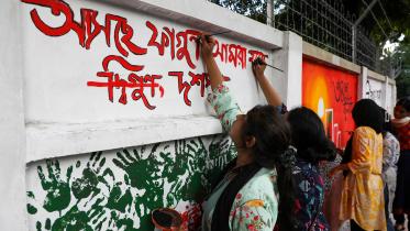 repainting vandalised walls Dhaka | Students paint over vandalised walls, give DU new life 