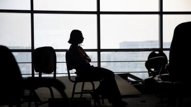 A person sitting in the dark