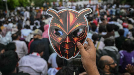 A Cockroach Janta Party (CJP) supporter holds a cockroach mask during a protest over alleged irregularities in the country's major examinations, in New Delhi on Saturday. Photo: AFP