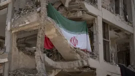 An Iranian flag hangs on a building targeted during Israeli attacks on a residential area in Tehran, Iran, on August 11, 2025, following the ceasefire between Iran and Israel after the 12-day war. Photo: AFP