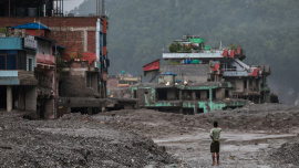 A man takes pictures in front of damaged buildings after flash floods and a mudslide, in Trishuli, Nuwakot district, Nepal, August 29, 2026. Photo: Reuters