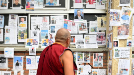 A Buddhist monk looks at photographs of missing and deceased people pasted on wall outside Tribhuvan University Teaching Hospital, following flash floods and a mudslide, in Kathmandu, Nepal, September 1, 2026. Photo: Reuters