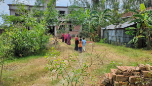 People gather in front of the family’s house as shock grips the area, leaving a heavy silence over the community after the news broke. Photo: Star