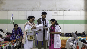 Medical interns examining reports. 