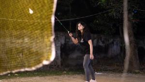 A person playing badminton. 