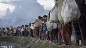 Rohingya refugees walk after crossing the Naf river from Myanmar into Bangladesh in Whaikhyang. File Photo: AFP