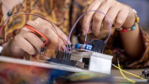 Person building a robot