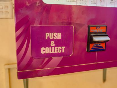 Push and collect feature for a sanitary pad vending machine