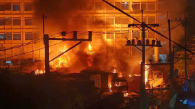 The fire broke out in the open parking area in front of the factories, which is used by vehicles transporting goods from the factories. Photo: Collected