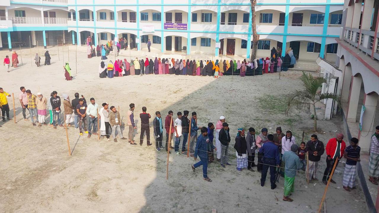 Voters stand in lines to cast their votes at a polling centre in Narayanganj's Rupganj
